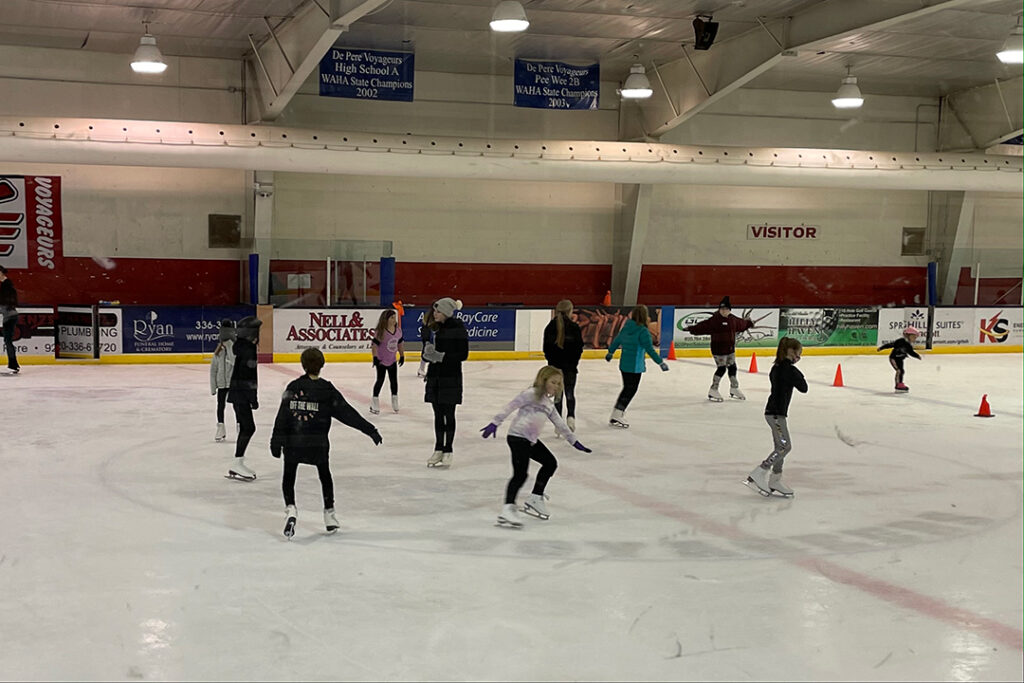 children skating on the ice rink